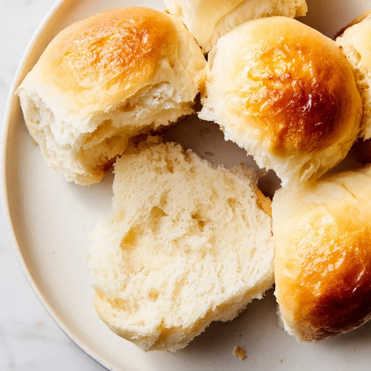 Golden, buttery quick-rise dinner rolls, fresh from the oven, ready for a delicious dinner.