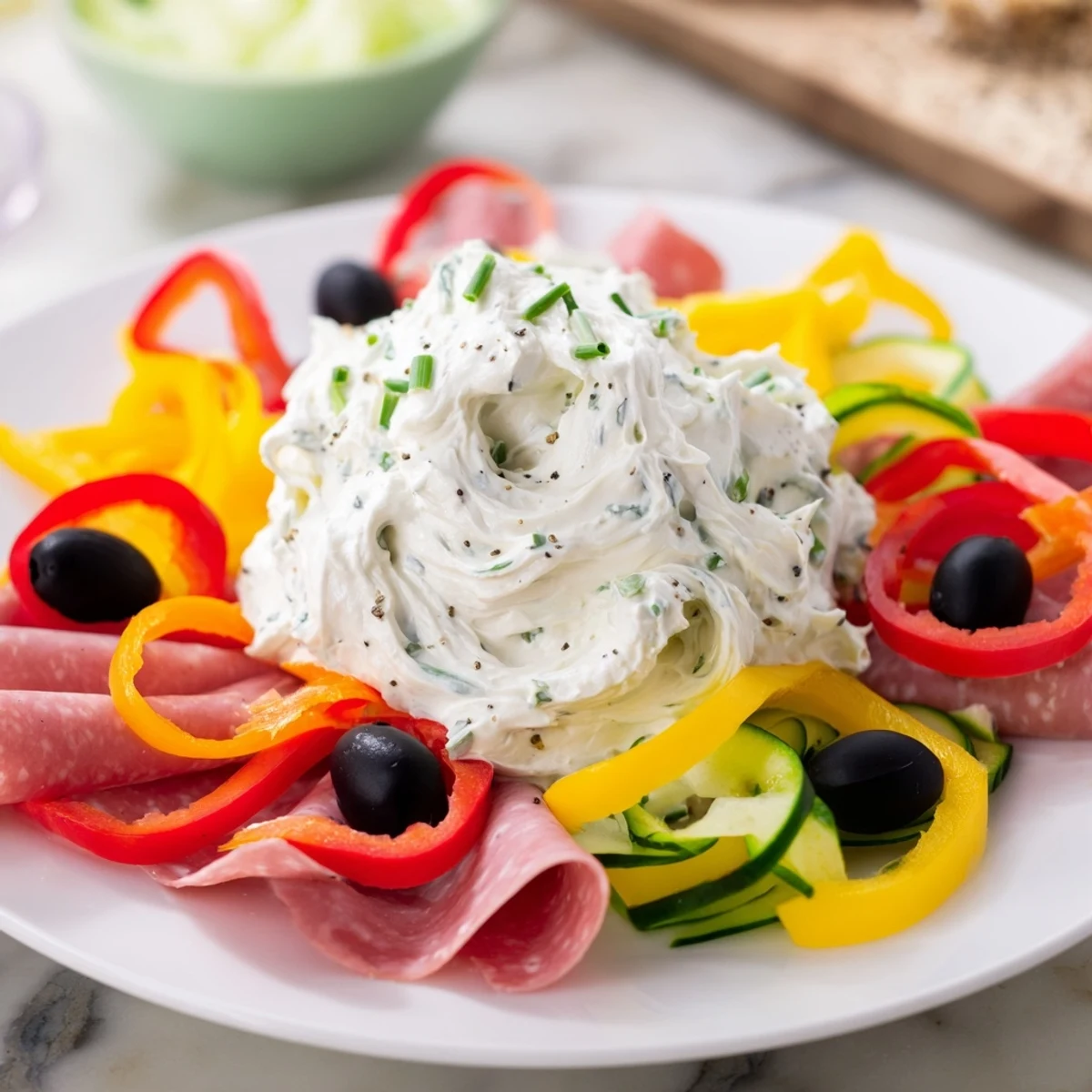 Party-ready Medusa Curls platter, featuring spirals of meat and vegetable "snakes" around a dip.