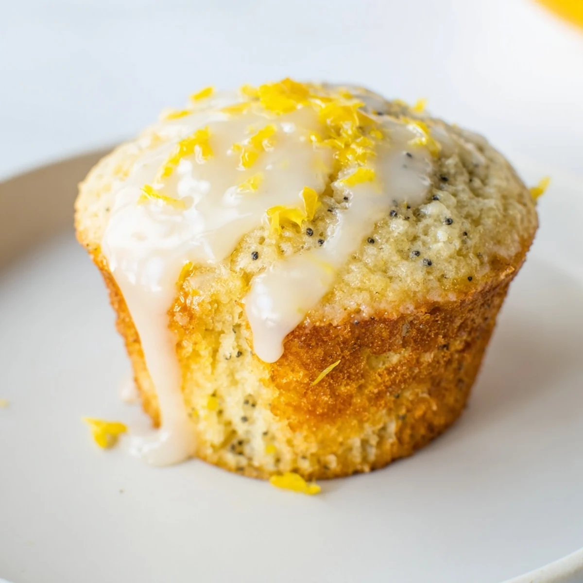 Fluffy Lemon Poppy Seed Muffins drizzled with glaze, perfect to enjoy with a cup of coffee on a sunny morning.