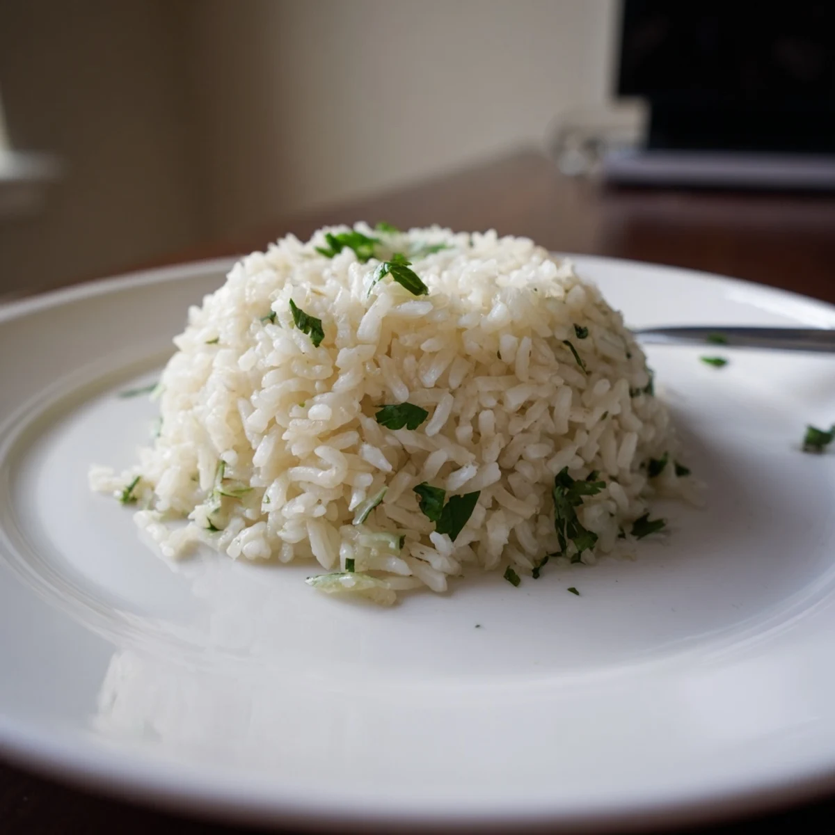 Steaming bowl of homemade Cilantro Lime Rice with zesty lime juice and chopped cilantro, perfect for vegan dinners.