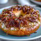 Golden-brown sourdough onion bagels with a crisp crust and tender crumb, ready to enjoy warm from the oven.  
