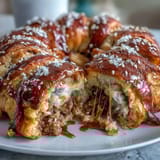 Golden puff pastry-wrapped cocktail sausages served with tangy honey Dijon mustard dip for game day snacking.