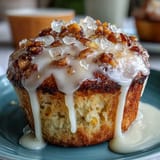Fluffy lemon poppy seed muffins with a bright citrus aroma and crunchy seed topping, drizzled with tangy lemon glaze for a springtime treat.