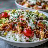 Salsa Chicken Bowls bursting with juicy shredded chicken, vibrant salsa, and colorful toppings served over fluffy rice.