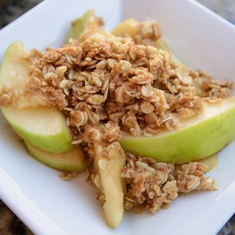 Golden, bubbly Rustic Apple and Cinnamon Crumb Bake, warm and ready for serving with vanilla ice cream.