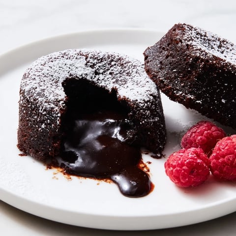 Molten chocolate spilling out of the rich, warm Mini Chocolate Lava Cakes, ready to be enjoyed.
