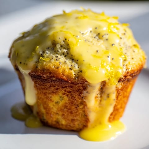 Golden-topped Lemon Poppy Seed Muffins, fresh from the oven, with a bright, citrusy aroma and inviting texture.