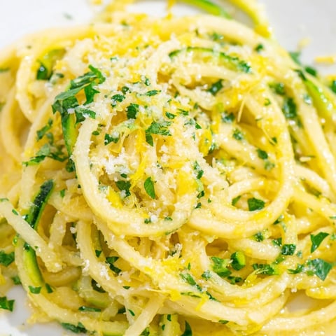 Tossed spiralized zucchini and al dente spaghetti in a bright lemon butter sauce, topped with fresh parsley and grated Parmesan for a fresh Italian-inspired dinner.