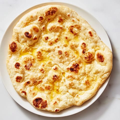 Freshly made Three-Ingredient Easy Flatbreads, softly puffed and ideal for a quick Mediterranean meal.