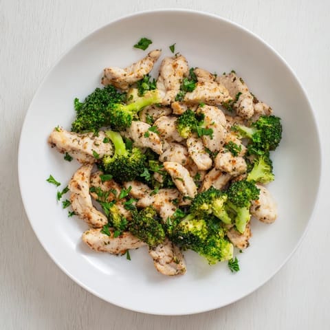 Fresh broccoli florets and chicken breast steaming in microwave, part of the Microwave-Steamed Chicken and Broccoli recipe.