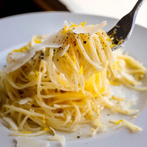 Steaming Lemon Butter Pasta piled high, tossed with olive oil and Parmesan for a quick vegetarian meal.