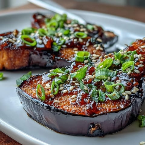 Roasted eggplant halves glazed with sweet and savory miso, caramelized under the broiler for an umami-rich vegetarian side dish.