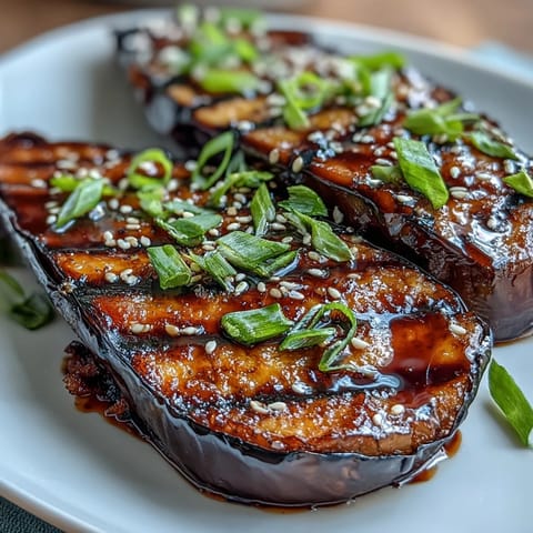 Tender eggplant roasted to perfection, topped with a glossy miso glaze that balances sweetness and savory depth in every bite.