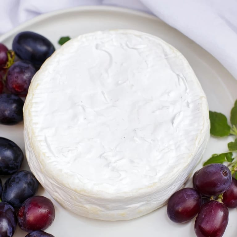 This vibrant appetizer, The Floating Island, boasts a stunning cheese wheel and grape-lined yogurt lake.