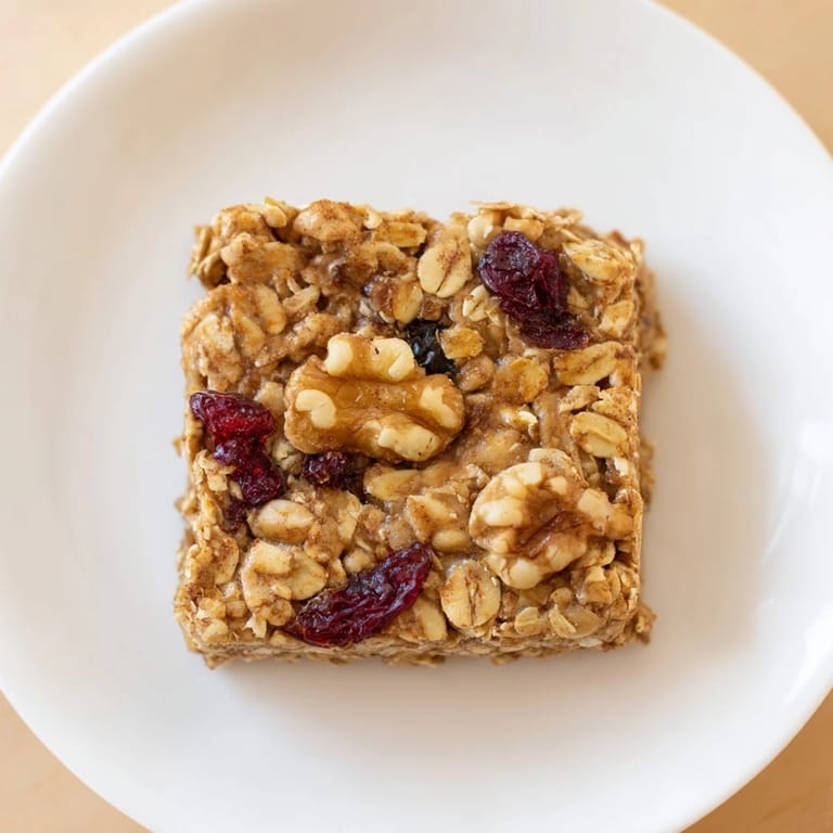 Homemade Maple Cinnamon Oatmeal Bars, beautifully baked and ready to eat, served with fresh fruit.
