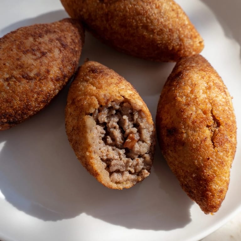 Freshly prepared Lebanese Kibbeh, showing a close-up of the flavorful, spiced meat patties.