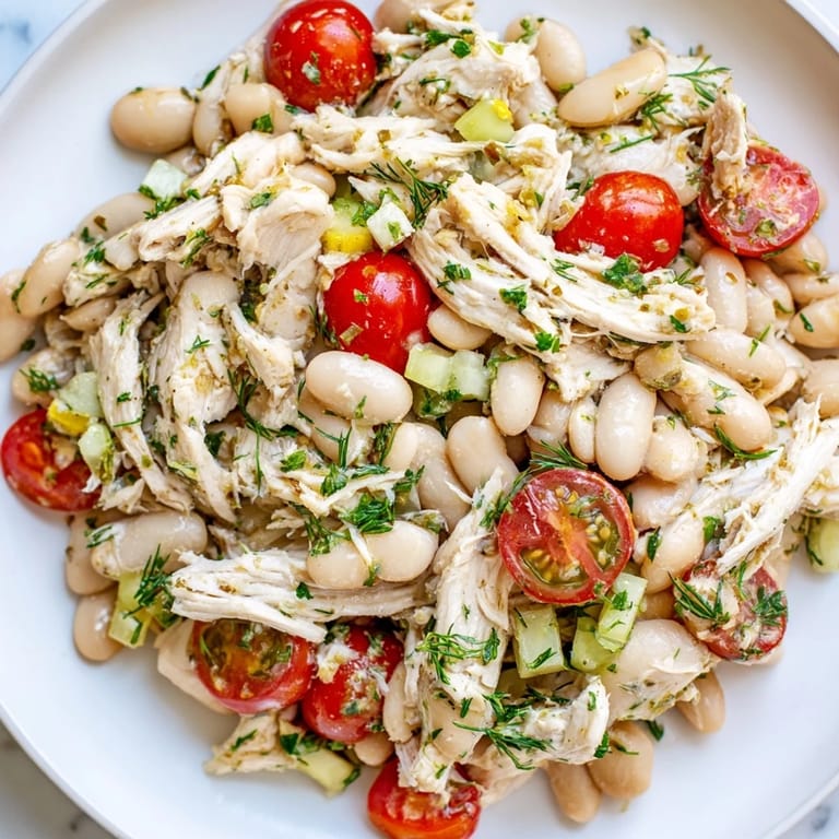 Close-up of Lemony White Bean Chicken Salad with diced celery, red onion, and fresh dill glistening with lemon dressing.